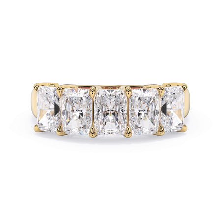 A picture of a five stone diamond wedding ring with radiant cut diamonds that are shared prong set in yellow gold on a white background with the ring facing forward, lying down.