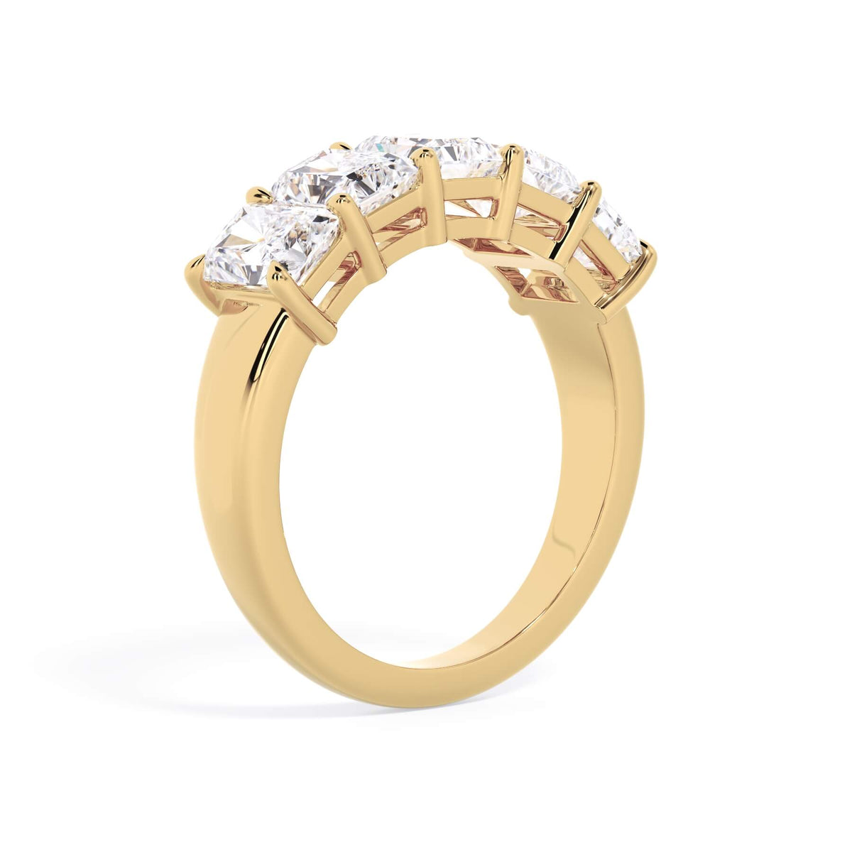 A picture of a five stone diamond wedding ring with radiant cut diamonds that are shared prong set in yellow gold on a white background with a slightly angled, through the finger view.