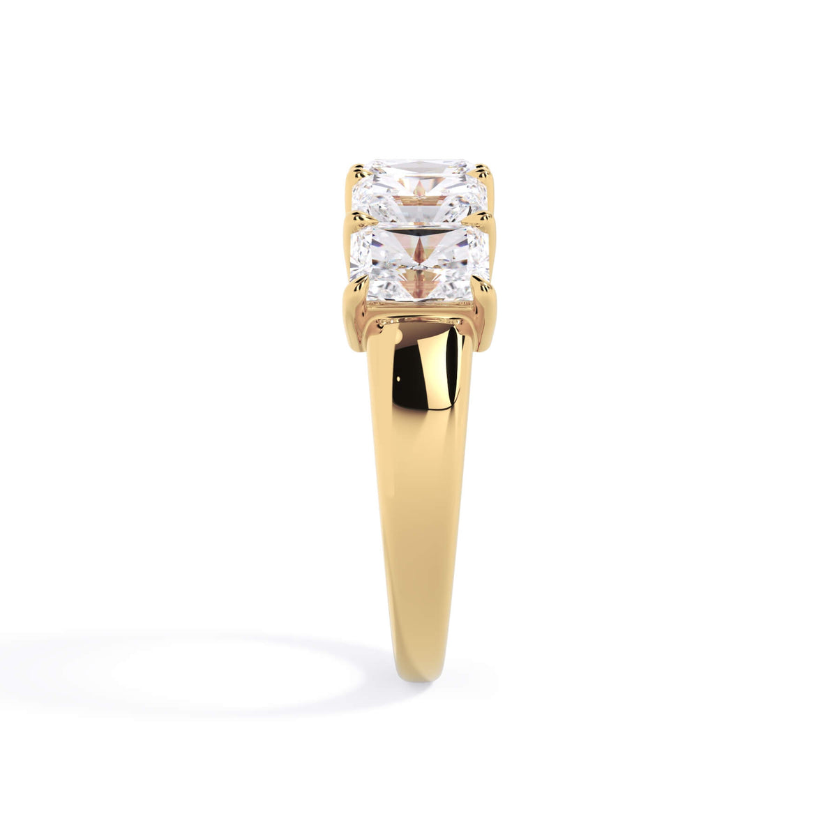 A picture of a five stone diamond wedding ring with radiant cut diamonds that are shared prong set in yellow gold on a white background with a side profile view.
