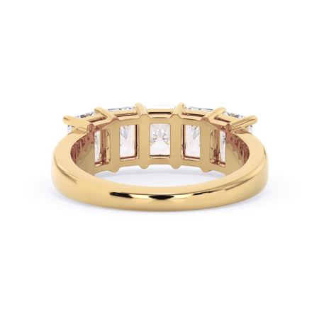 A picture of a five stone diamond wedding ring with radiant cut diamonds that are shared prong set in yellow gold on a white background with a view of the underside of the ring.