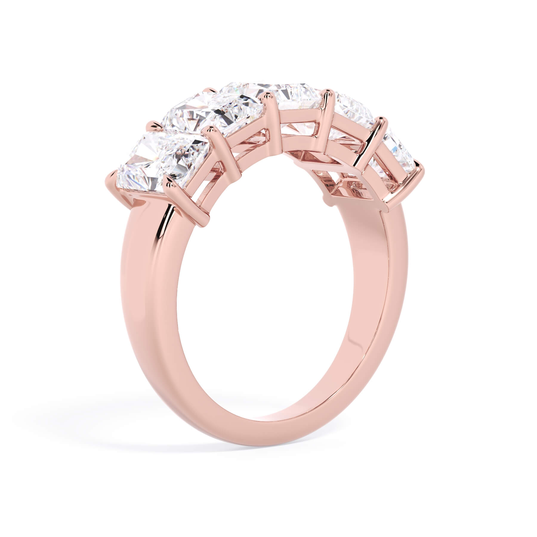 A picture of a five stone diamond wedding ring with radiant cut diamonds that are shared prong set in rose gold on a white background with a slightly angled, through the finger view.