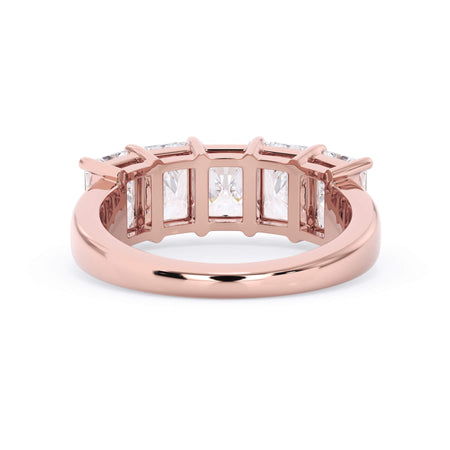 A picture of a five stone diamond wedding ring with radiant cut diamonds that are shared prong set in rose gold on a white background with a view of the underside of the ring.
