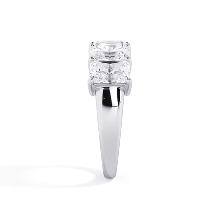 A picture of a five stone diamond wedding ring with radiant cut diamonds that are shared prong set in white gold or platinum on a white background with a side profile view.