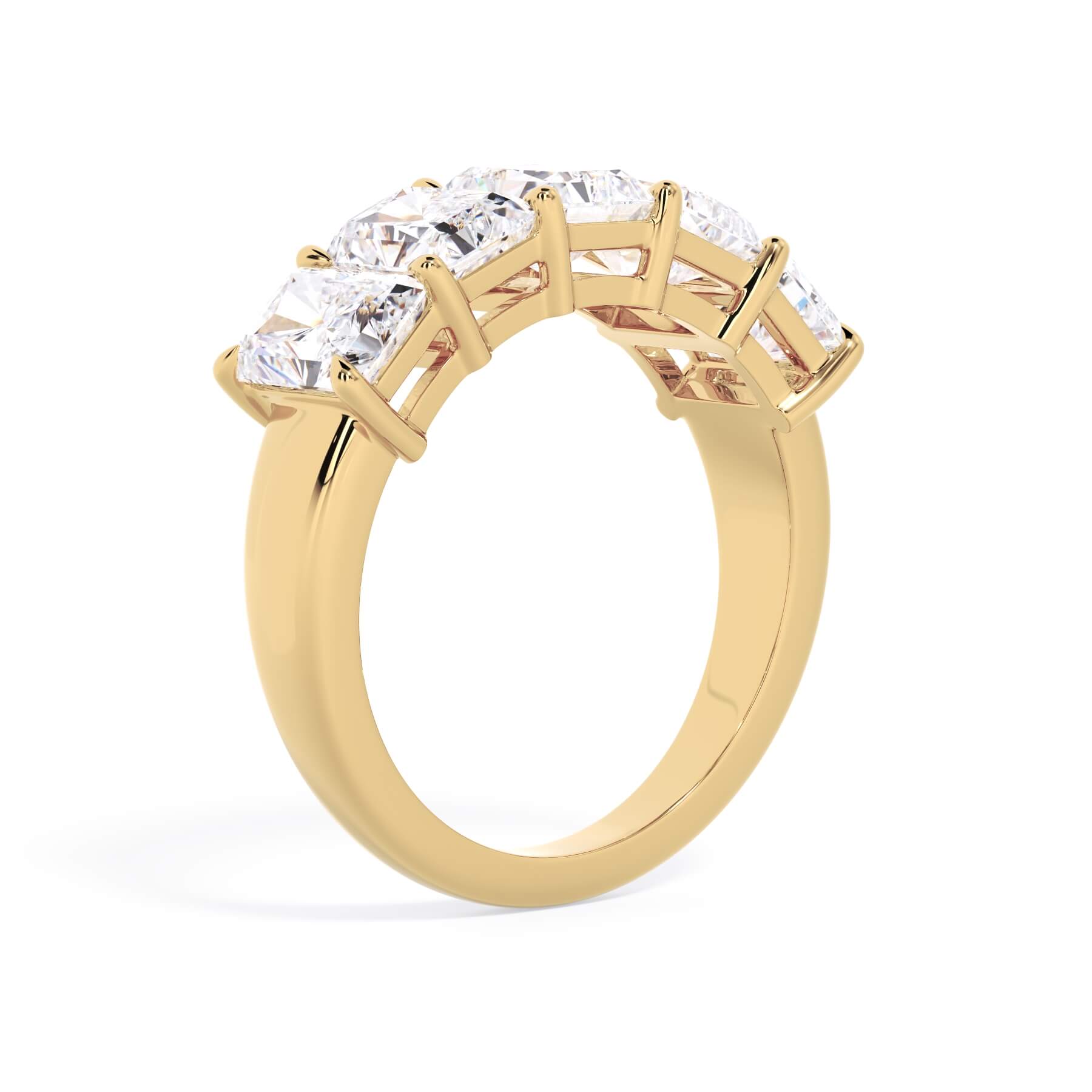 A picture of a five stone diamond wedding ring with radiant cut diamonds that are shared prong set in yellow gold on a white background with a slightly angled, through the finger view.