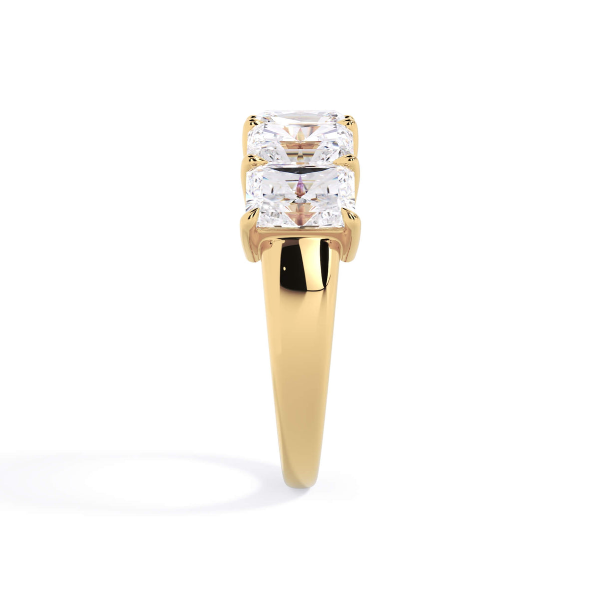 A picture of a five stone diamond wedding ring with radiant cut diamonds that are shared prong set in yellow gold on a white background with a side profile view.