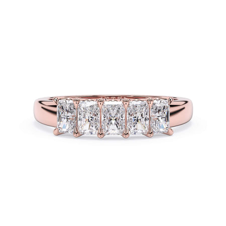 A picture of a five stone diamond wedding ring with radiant cut diamonds that are u prong set in rose gold on a white background with the ring facing forward, lying down.