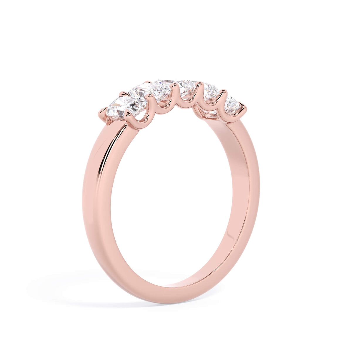 A picture of a five stone diamond wedding ring with radiant cut diamonds that are u prong set in rose gold on a white background with a slightly angled, through the finger view.