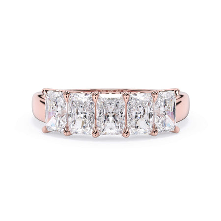 A picture of a five stone diamond wedding ring with radiant cut diamonds that are u prong set in rose gold on a white background with the ring facing forward, lying down.