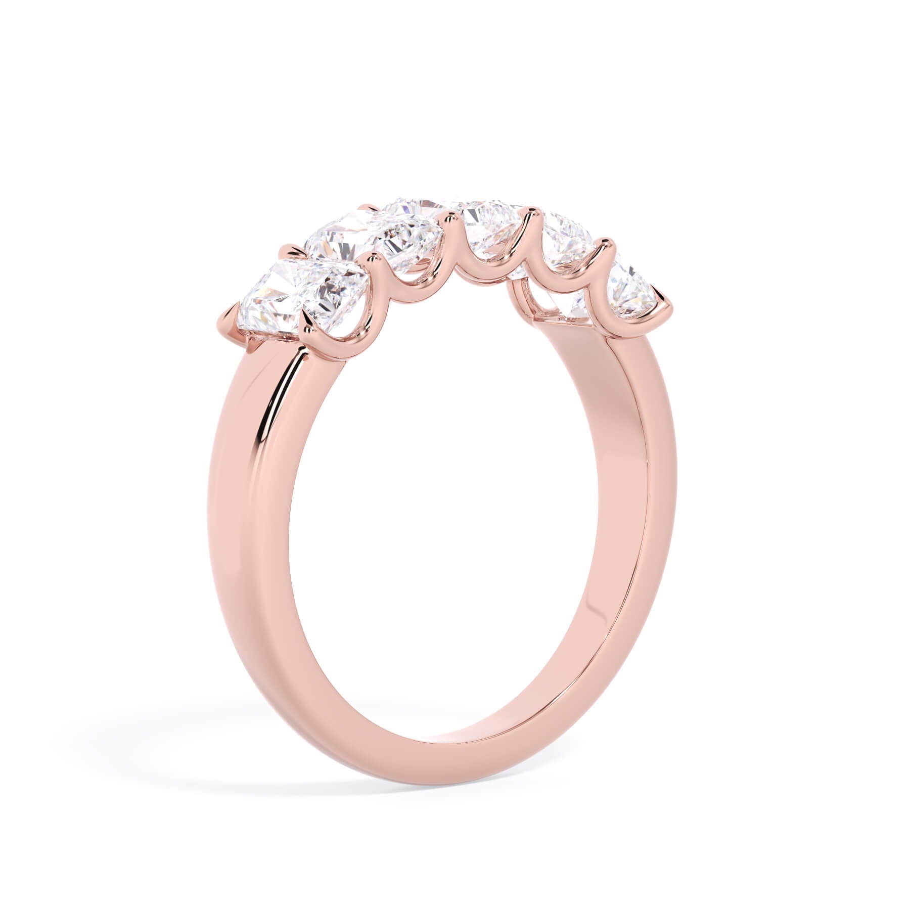 A picture of a five stone diamond wedding ring with radiant cut diamonds that are u prong set in rose gold on a white background with a slightly angled, through the finger view.