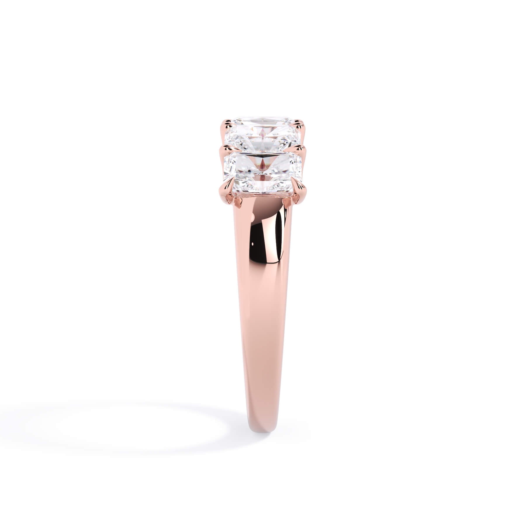 A picture of a five stone diamond wedding ring with radiant cut diamonds that are u prong set in rose gold on a white background with a side profile view.