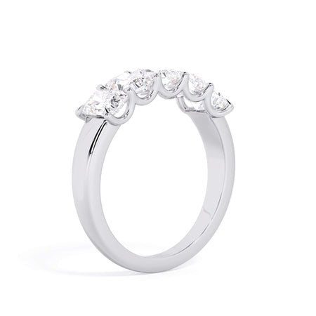 A picture of a five stone diamond wedding ring with radiant cut diamonds that are u prong set in white gold or platinum on a white background with a slightly angled, through the finger view.