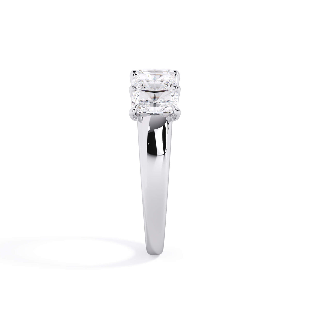 A picture of a five stone diamond wedding ring with radiant cut diamonds that are u prong set in white gold or platinum on a white background with a side profile view.
