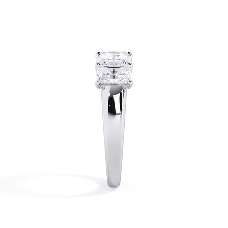 A picture of a five stone diamond wedding ring with radiant cut diamonds that are u prong set in white gold or platinum on a white background with a side profile view.