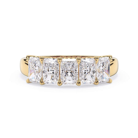 A picture of a five stone diamond wedding ring with radiant cut diamonds that are u prong set in yellow gold on a white background with the ring facing forward, lying down.