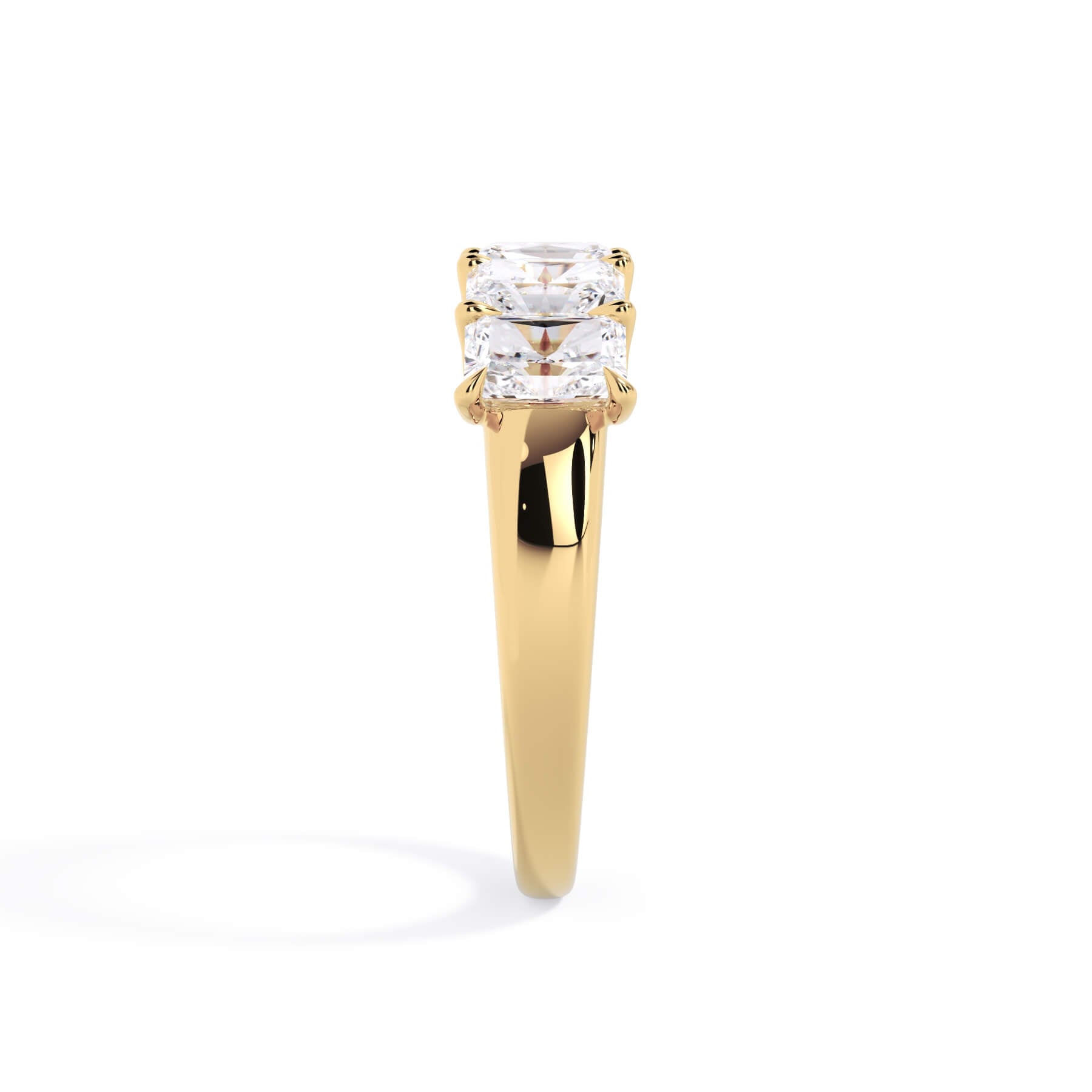 A picture of a five stone diamond wedding ring with radiant cut diamonds that are u prong set in yellow gold on a white background with a side profile view.