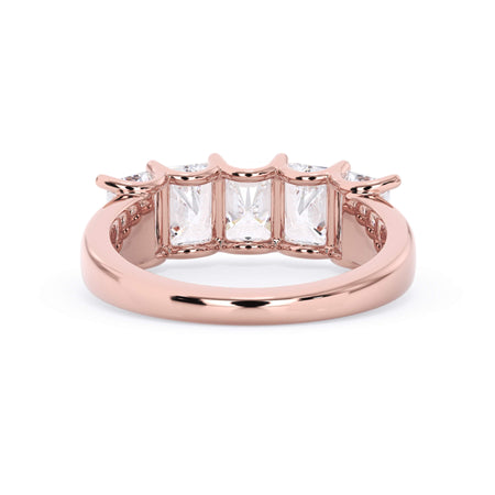 A picture of a five stone diamond wedding ring with radiant cut diamonds that are u prong set in rose gold on a white background with a view of the underside of the ring.