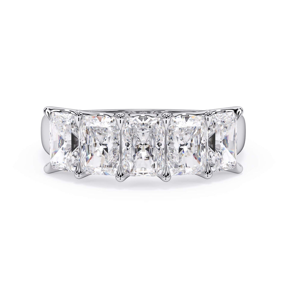 A picture of a five stone diamond wedding ring with radiant cut diamonds that are u prong set in white gold or platinum on a white background with the ring facing forward, lying down.