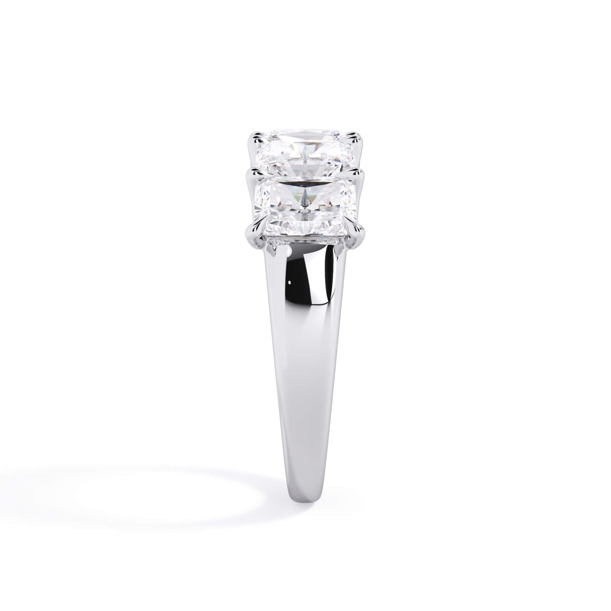 A picture of a five stone diamond wedding ring with radiant cut diamonds that are u prong set in white gold or platinum on a white background with a side profile view.