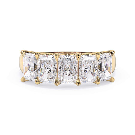 A picture of a five stone diamond wedding ring with radiant cut diamonds that are u prong set in yellow gold on a white background with the ring facing forward, lying down.