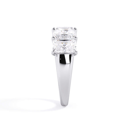A picture of a five stone diamond wedding ring with radiant cut diamonds that are u prong set in white gold or platinum on a white background with a side profile view.