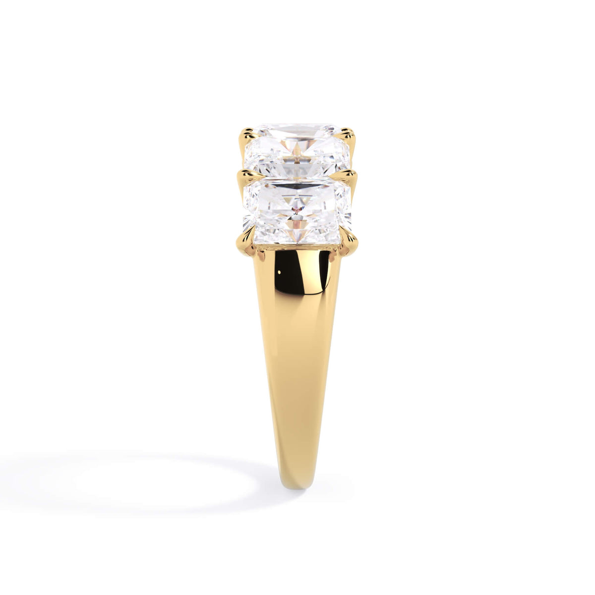 A picture of a five stone diamond wedding ring with radiant cut diamonds that are u prong set in yellow gold on a white background with a side profile view.