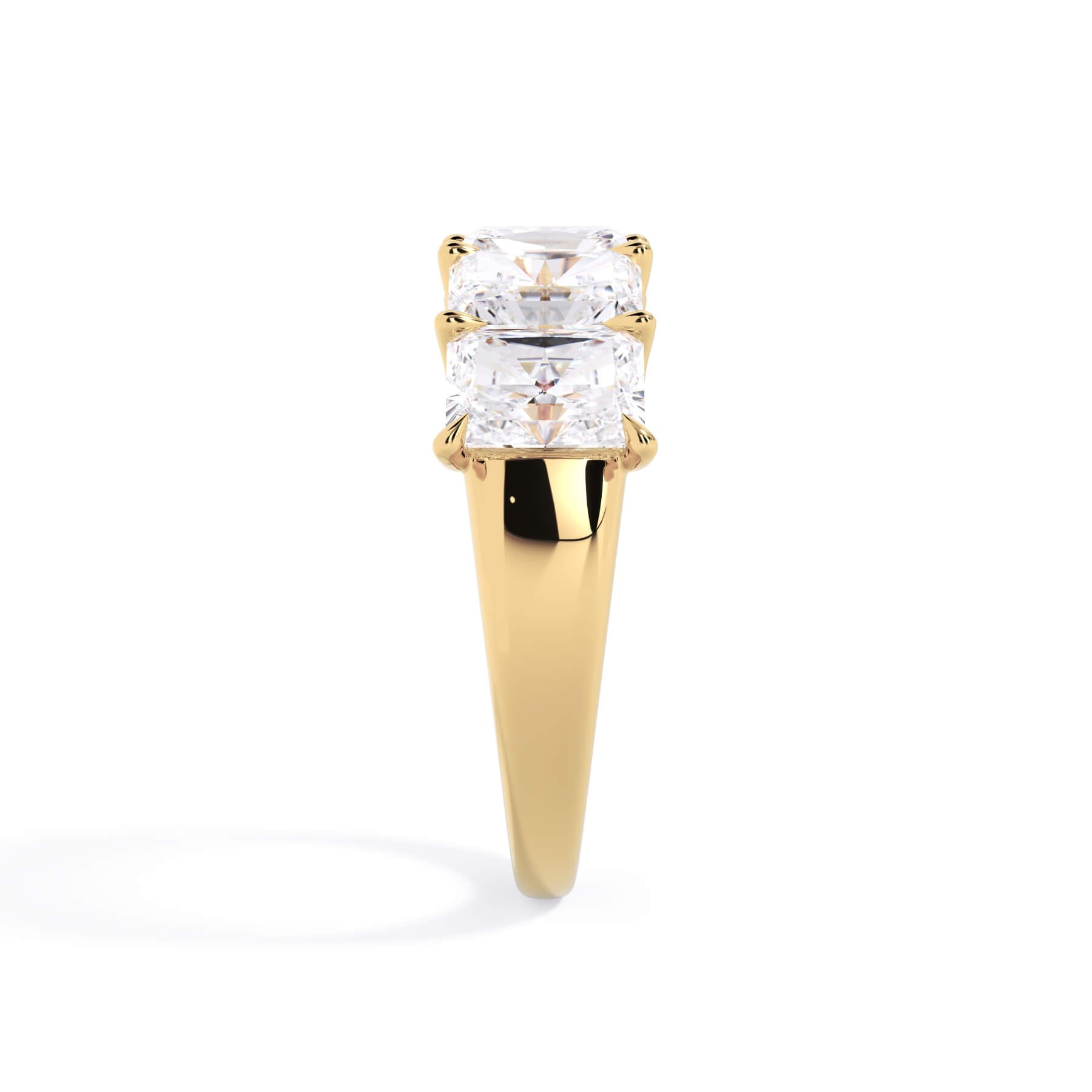 A picture of a five stone diamond wedding ring with radiant cut diamonds that are u prong set in yellow gold on a white background with a side profile view.