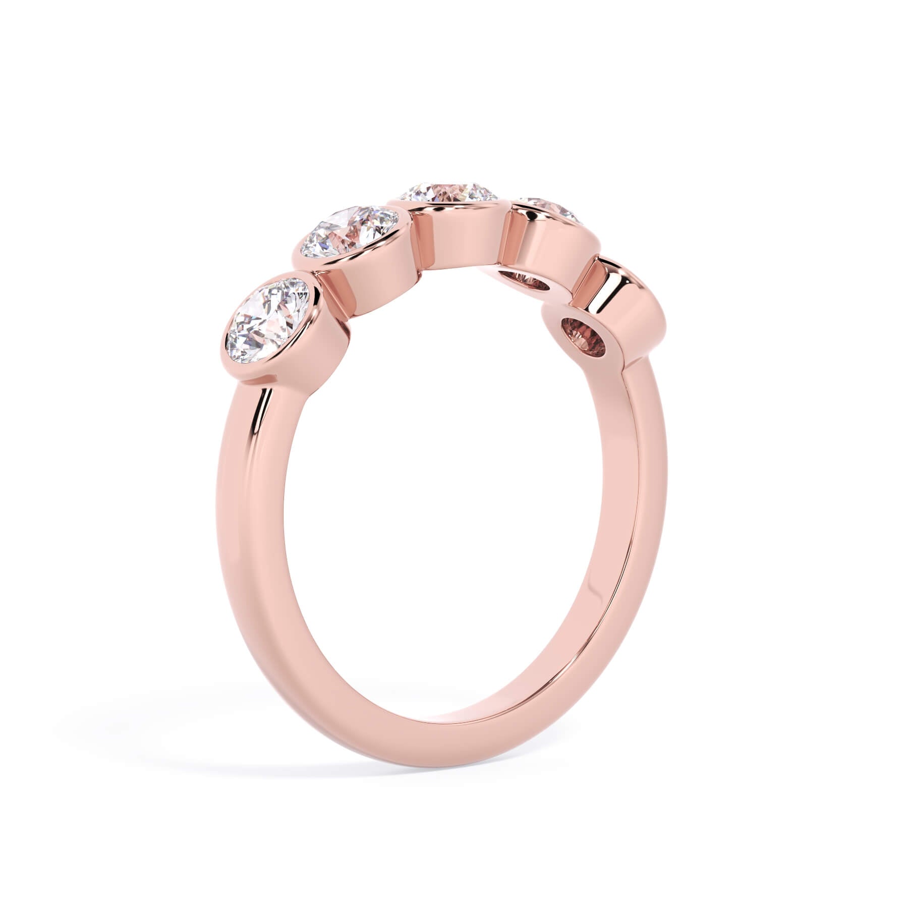 A picture of a five stone diamond wedding ring with round diamonds that are bezel set in rose gold on a white background with a slightly angled, through the finger view.