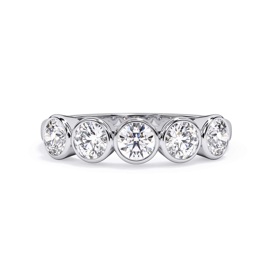 A picture of a five stone diamond wedding ring with round diamonds that are bezel set in white gold or platinum on a white background with the ring facing forward, lying down.