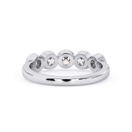 A picture of a five stone diamond wedding ring with round diamonds that are bezel set in white gold or platinum on a white background with a view of the underside of the ring.