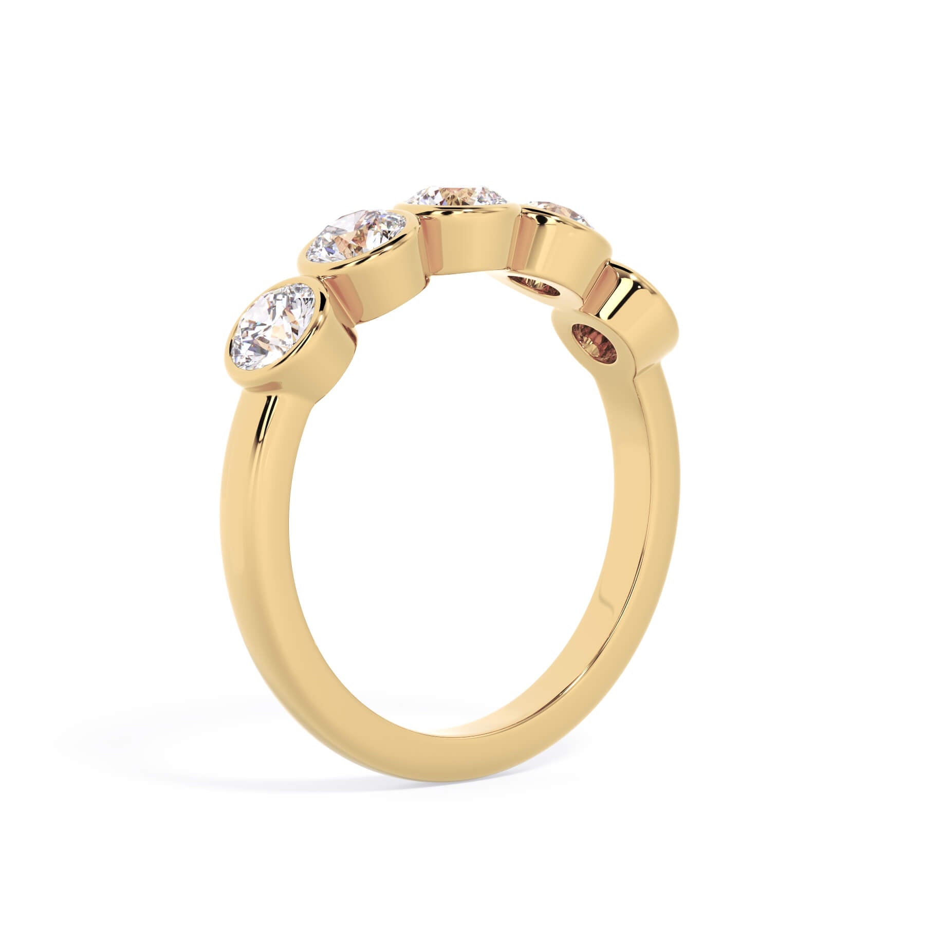 A picture of a five stone diamond wedding ring with round diamonds that are bezel set in yellow gold on a white background with a slightly angled, through the finger view.
