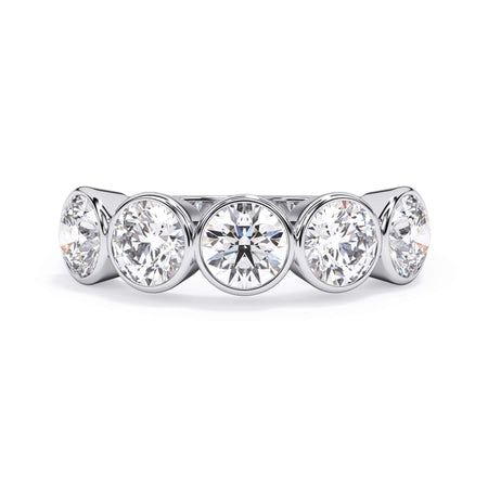 A picture of a five stone diamond wedding ring with round diamonds that are bezel set in white gold or platinum on a white background with the ring facing forward, lying down.