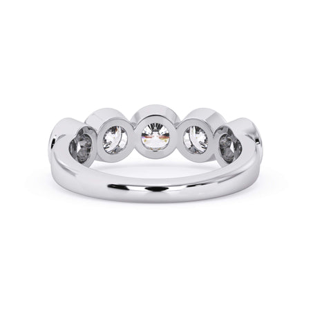 A picture of a five stone diamond wedding ring with round diamonds that are bezel set in white gold or platinum on a white background with a view of the underside of the ring.