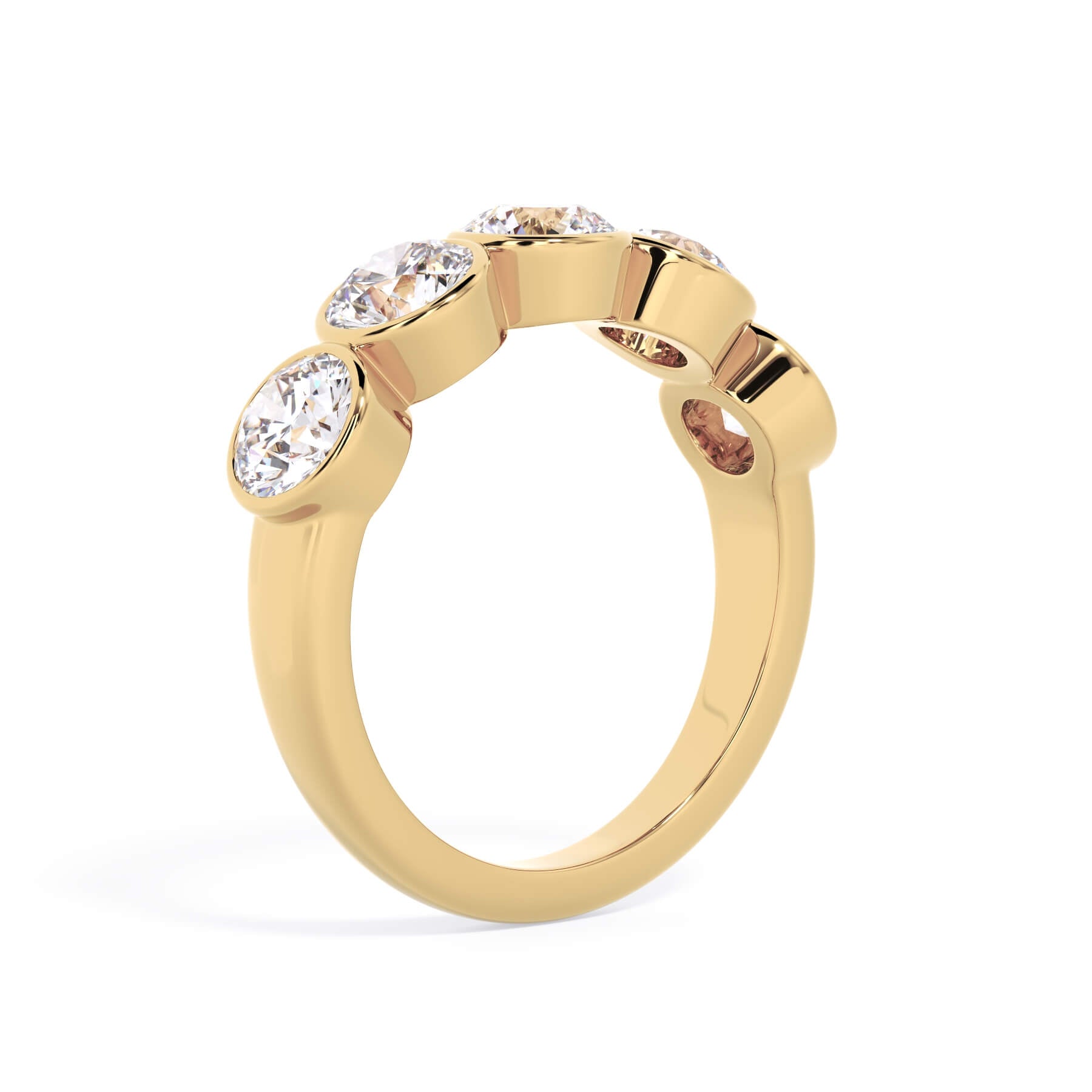 A picture of a five stone diamond wedding ring with round diamonds that are bezel set in yellow gold on a white background with a slightly angled, through the finger view.