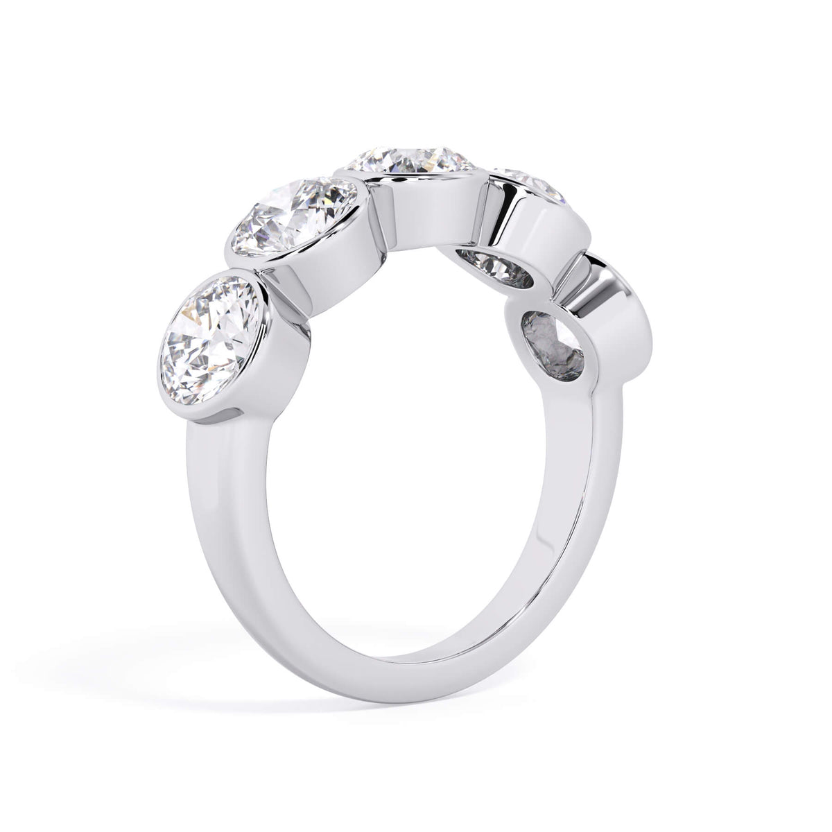 A picture of a five stone diamond wedding ring with round diamonds that are bezel set in white gold or platinum on a white background with a slightly angled, through the finger view.