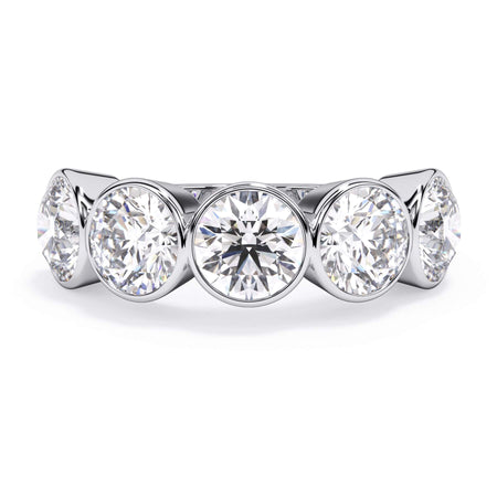 A picture of a five stone diamond wedding ring with round diamonds that are bezel set in white gold or platinum on a white background with the ring facing forward, lying down.