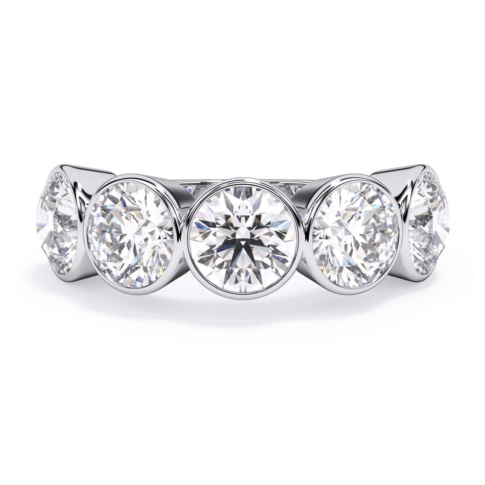 A picture of a five stone diamond wedding ring with round diamonds that are bezel set in white gold or platinum on a white background with the ring facing forward, lying down.