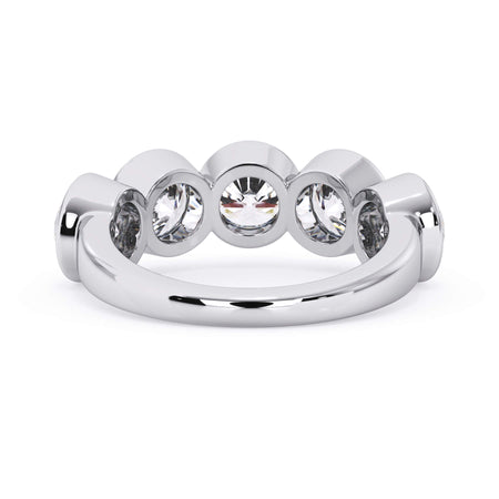 A picture of a five stone diamond wedding ring with round diamonds that are bezel set in white gold or platinum on a white background with a view of the underside of the ring.