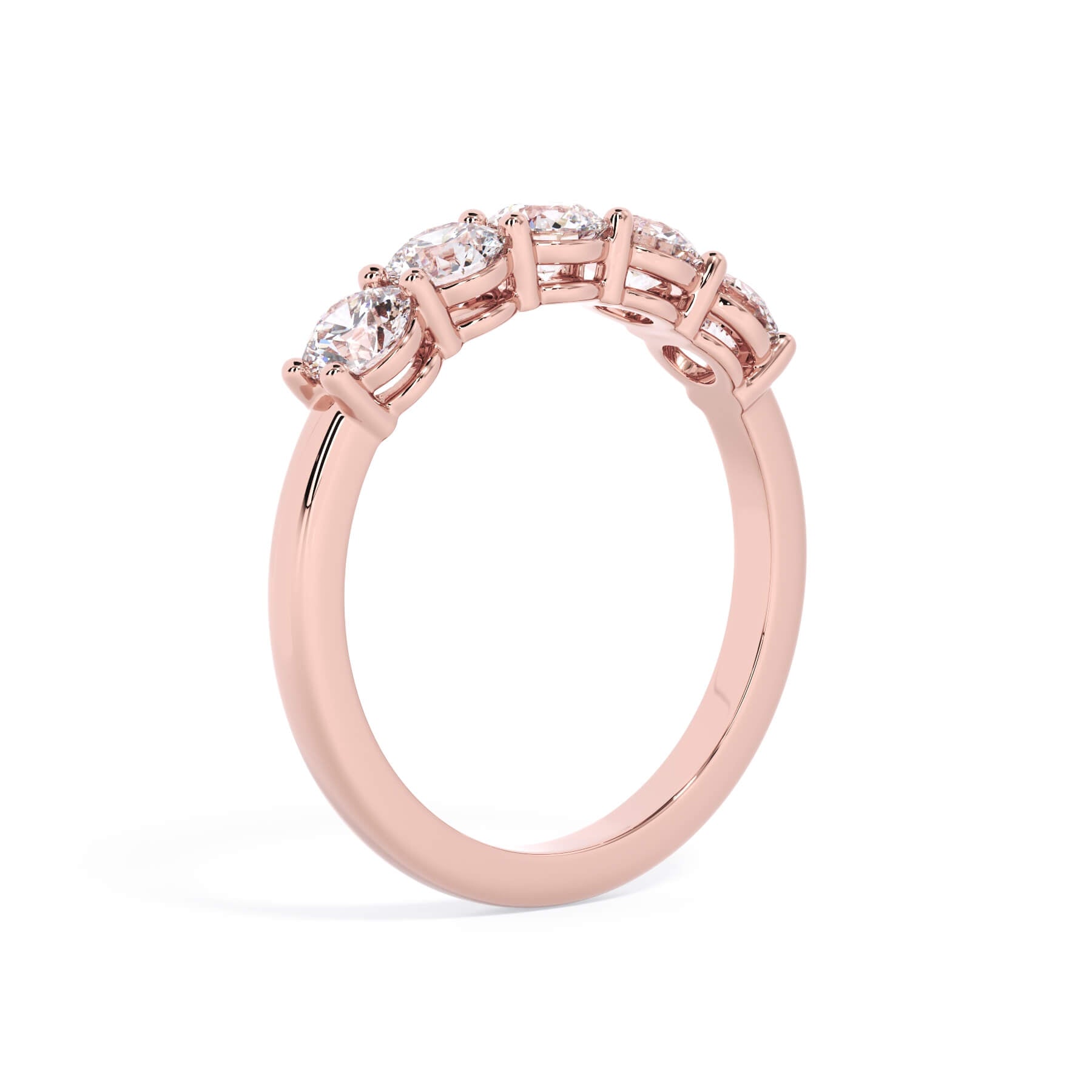 A picture of a five stone diamond wedding ring with round diamonds that are shared prong set in rose gold on a white background with a slightly angled, through the finger view.