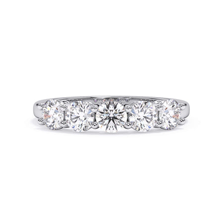 A picture of a five stone diamond wedding ring with round diamonds that are shared prong set in white gold or platinum on a white background with the ring facing forward, lying down.