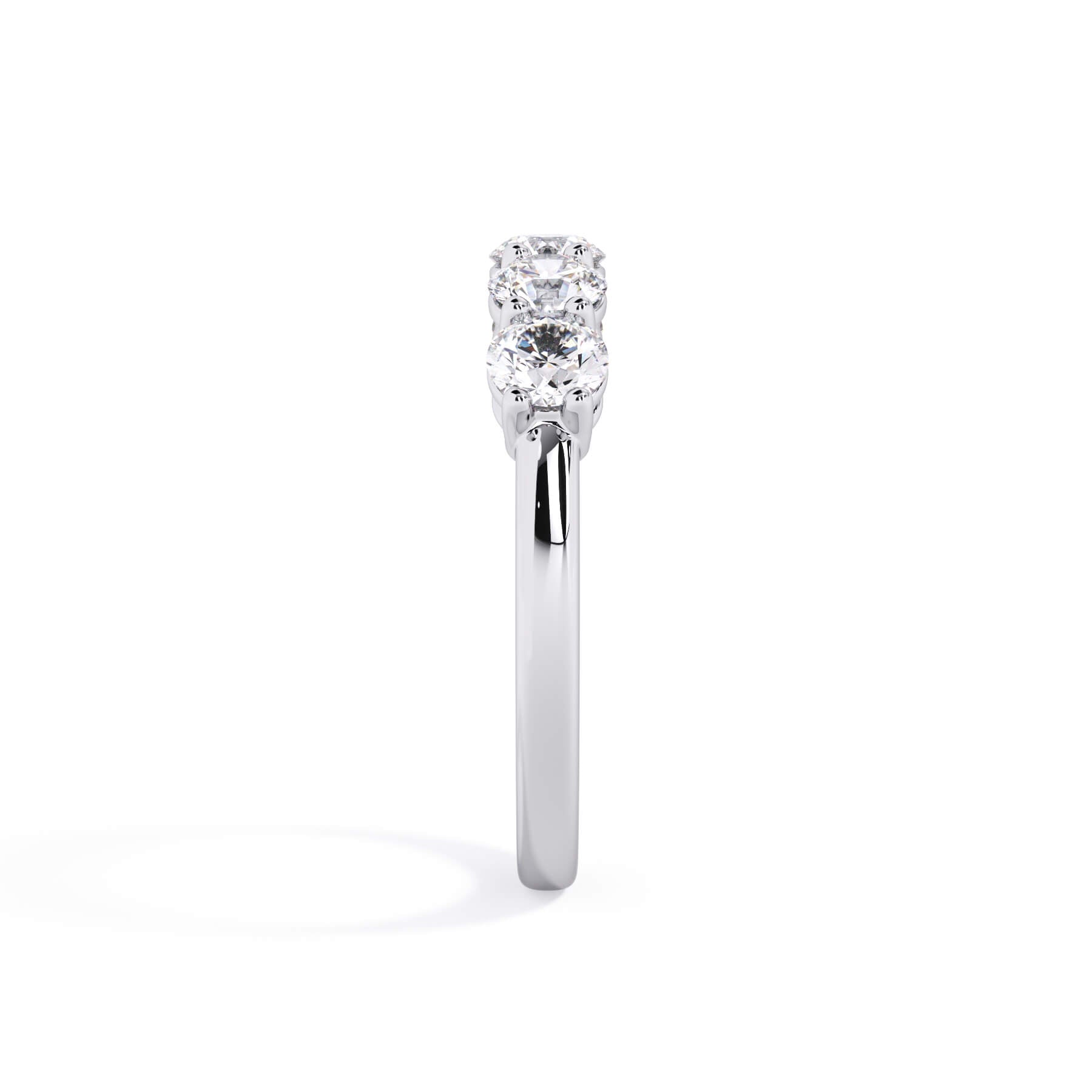 A picture of a five stone diamond wedding ring with round diamonds that are shared prong set in white gold or platinum on a white background with a side profile view.