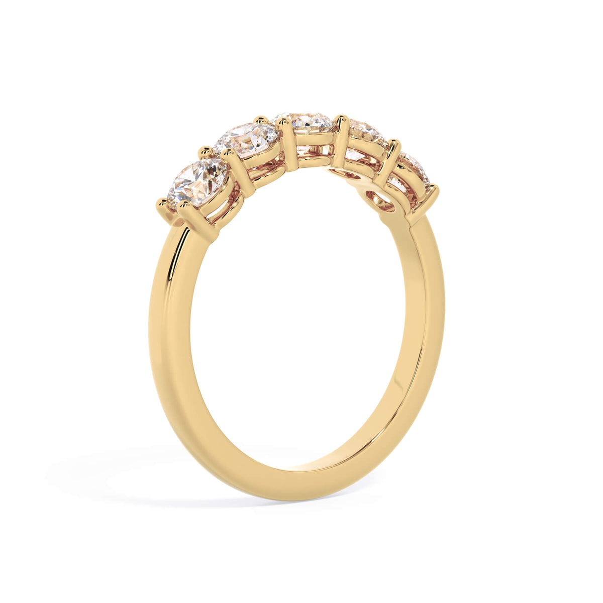 A picture of a five stone diamond wedding ring with round diamonds that are shared prong set in yellow gold on a white background with a slightly angled, through the finger view.