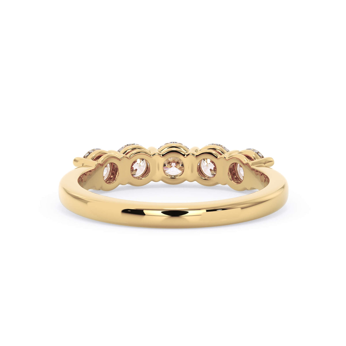 A picture of a five stone diamond wedding ring with round diamonds that are shared prong set in yellow gold on a white background with a view of the underside of the ring.
