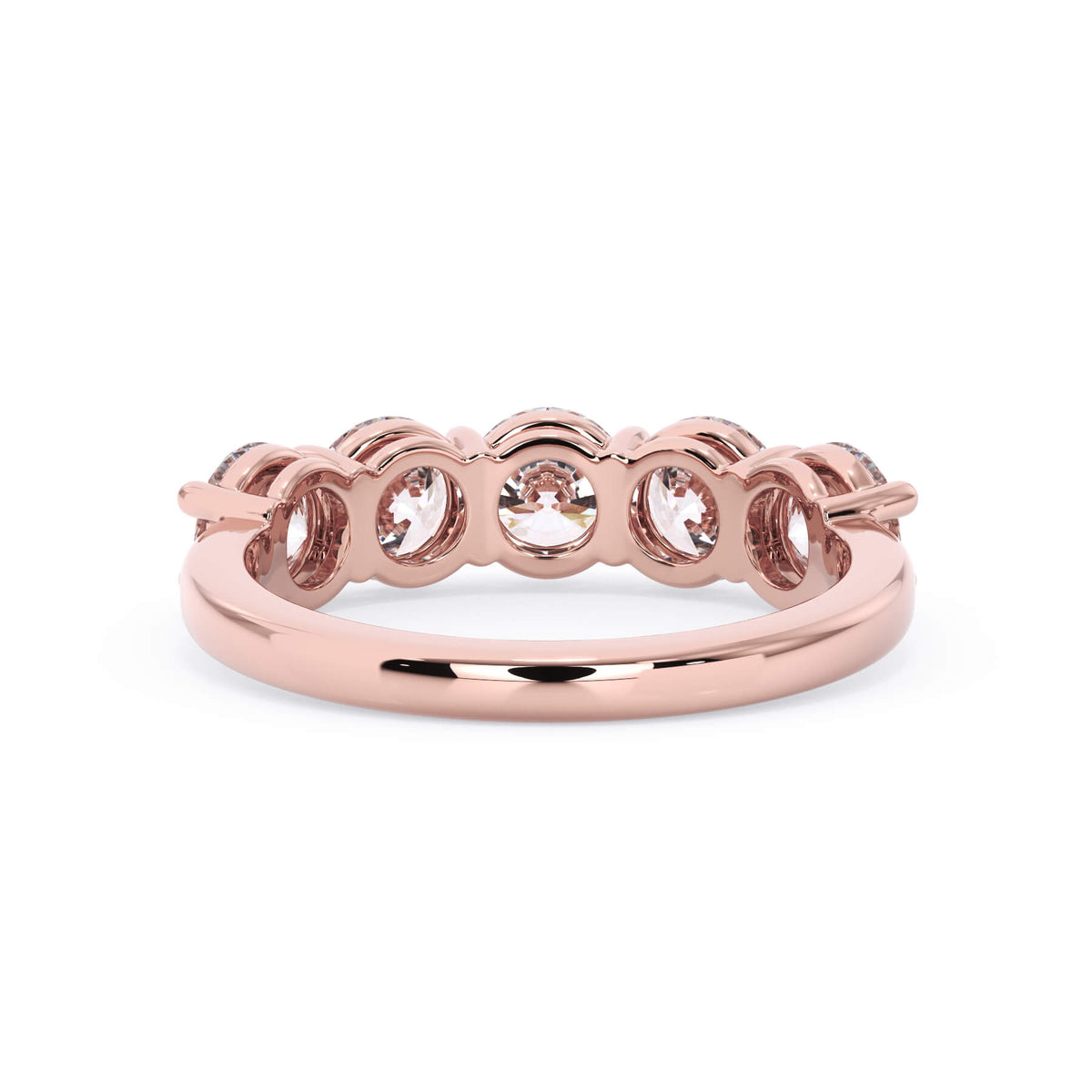 A picture of a five stone diamond wedding ring with round diamonds that are shared prong set in rose gold on a white background with a view of the underside of the ring.