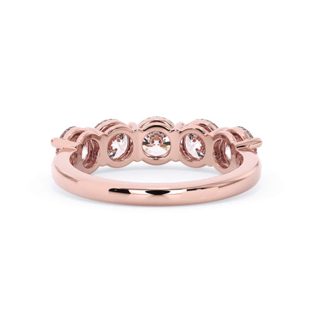 A picture of a five stone diamond wedding ring with round diamonds that are shared prong set in rose gold on a white background with a view of the underside of the ring.