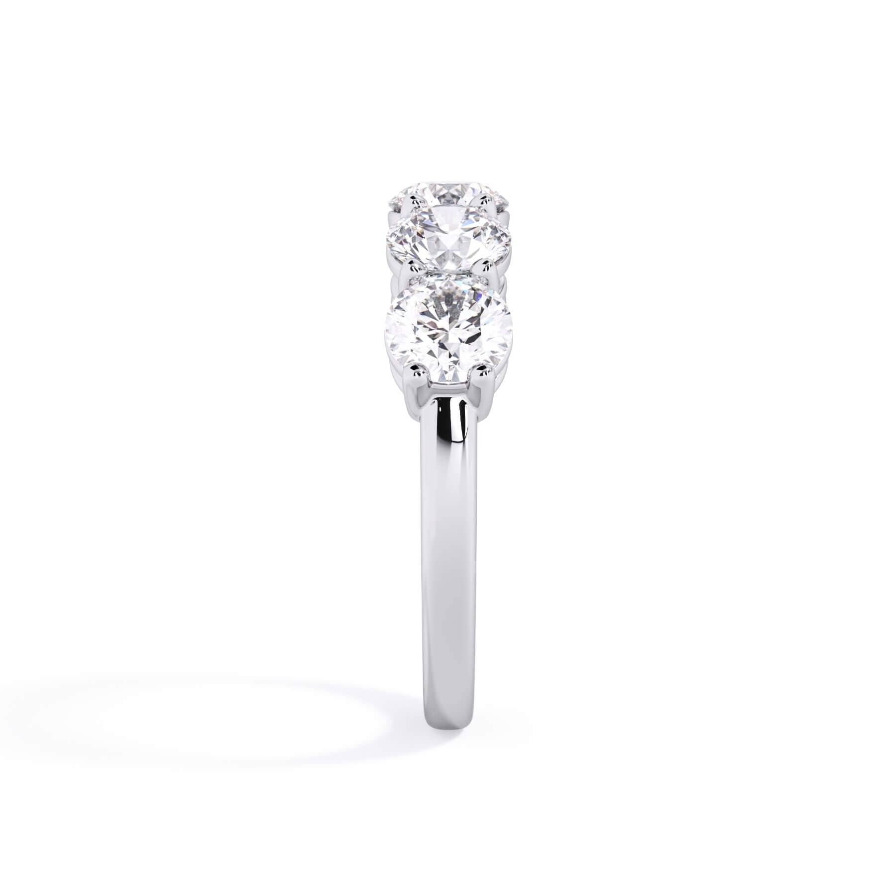 A picture of a five stone diamond wedding ring with round diamonds that are shared prong set in white gold or platinum on a white background with a side profile view.