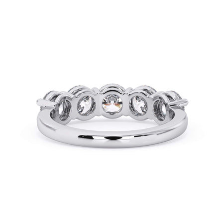 A picture of a five stone diamond wedding ring with round diamonds that are shared prong set in white gold or platinum on a white background with a view of the underside of the ring.