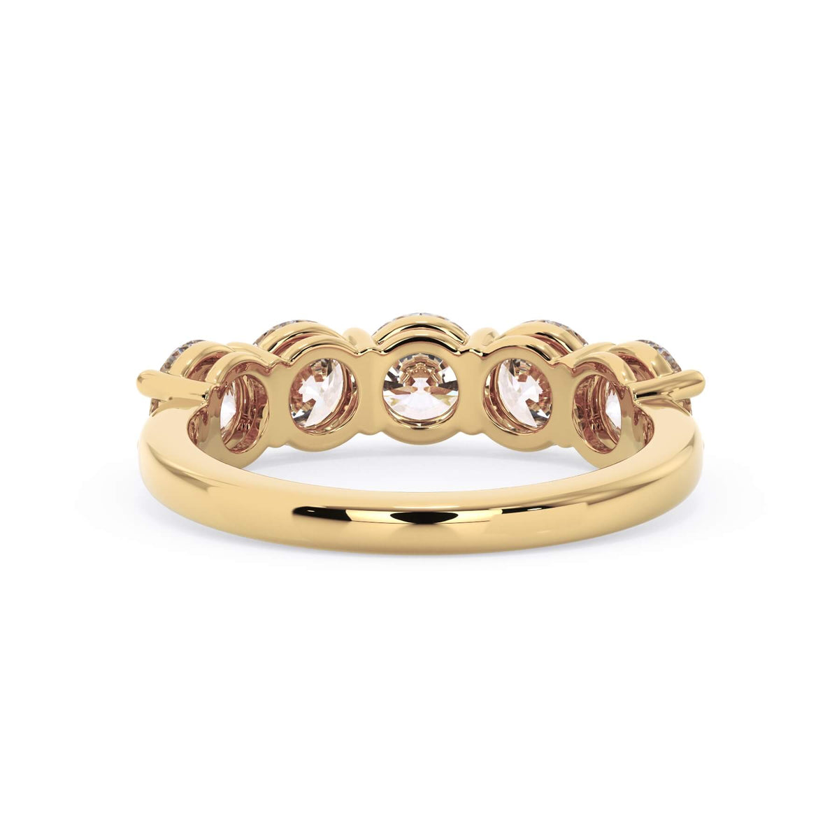 A picture of a five stone diamond wedding ring with round diamonds that are shared prong set in yellow gold on a white background with a view of the underside of the ring.