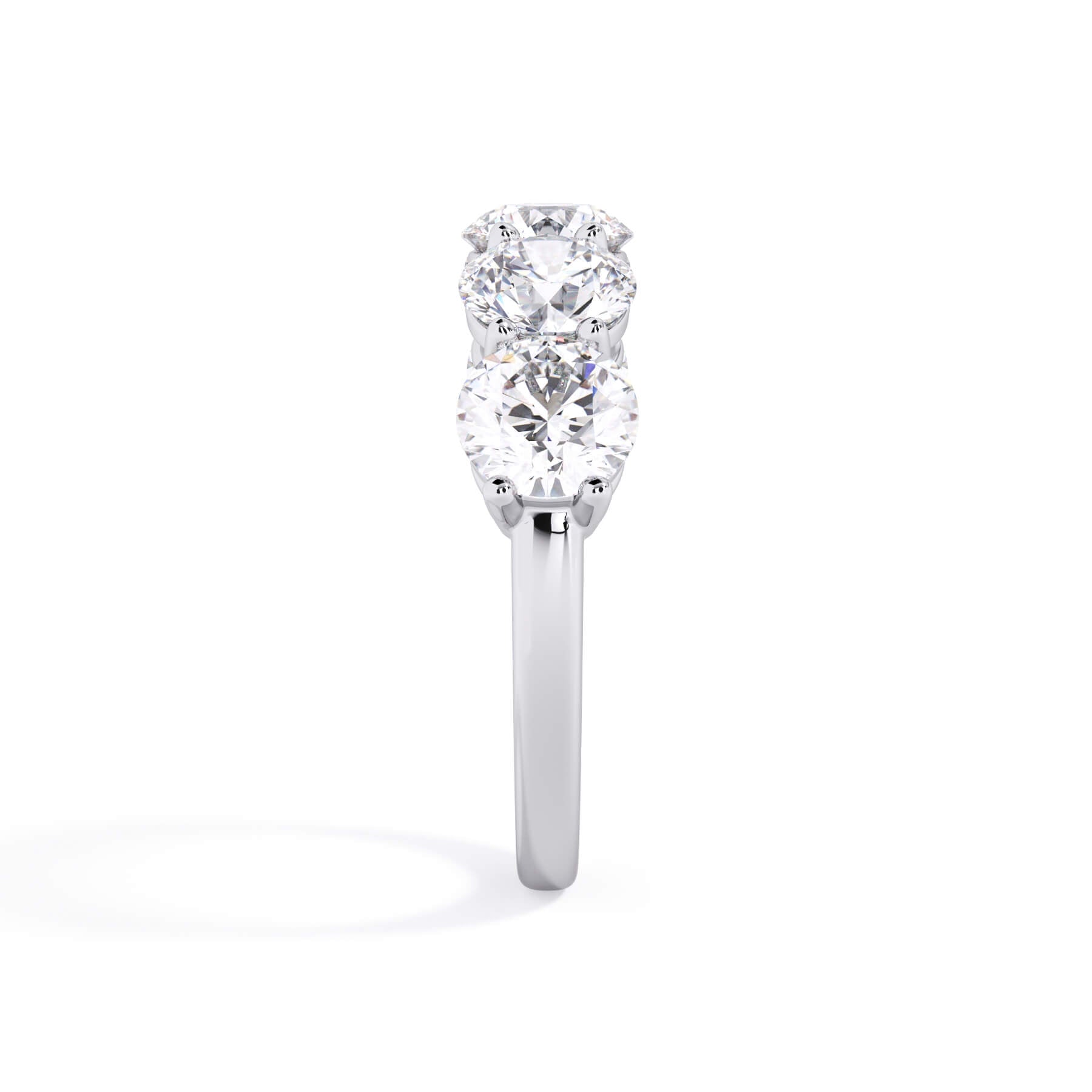 A picture of a five stone diamond wedding ring with round diamonds that are shared prong set in white gold or platinum on a white background with a side profile view.