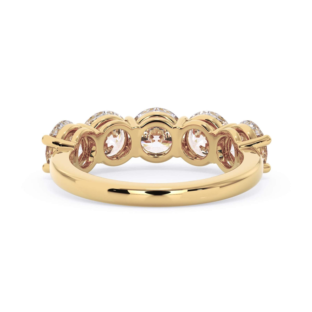 A picture of a five stone diamond wedding ring with round diamonds that are shared prong set in yellow gold on a white background with a view of the underside of the ring.