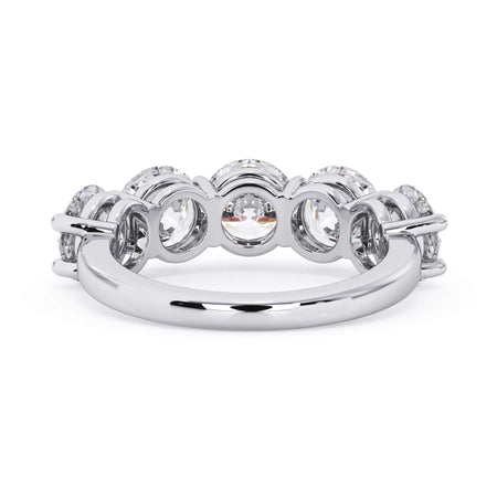 A picture of a five stone diamond wedding ring with round diamonds that are shared prong set in white gold or platinum on a white background with a view of the underside of the ring.